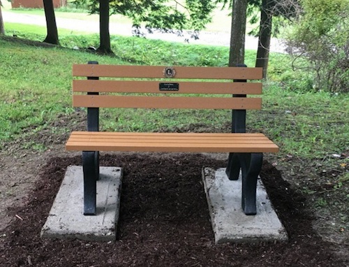 Owego Lions place a bench at Lions Camp Badger to honor their deceased members