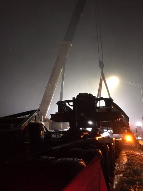 Crane helps remove large piece of machinery off 17