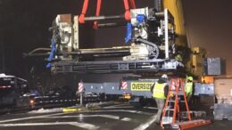 Crane helps remove large piece of machinery off 17