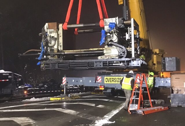 Crane helps remove large piece of machinery off 17