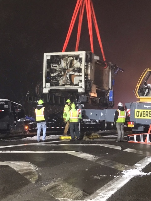 Crane helps remove large piece of machinery off 17