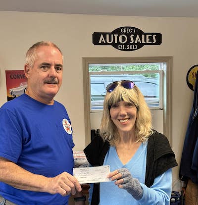 Greg Kies Auto Sales presents check for Village Appreciation Night